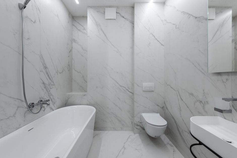 Contractor installing bathroom tiles